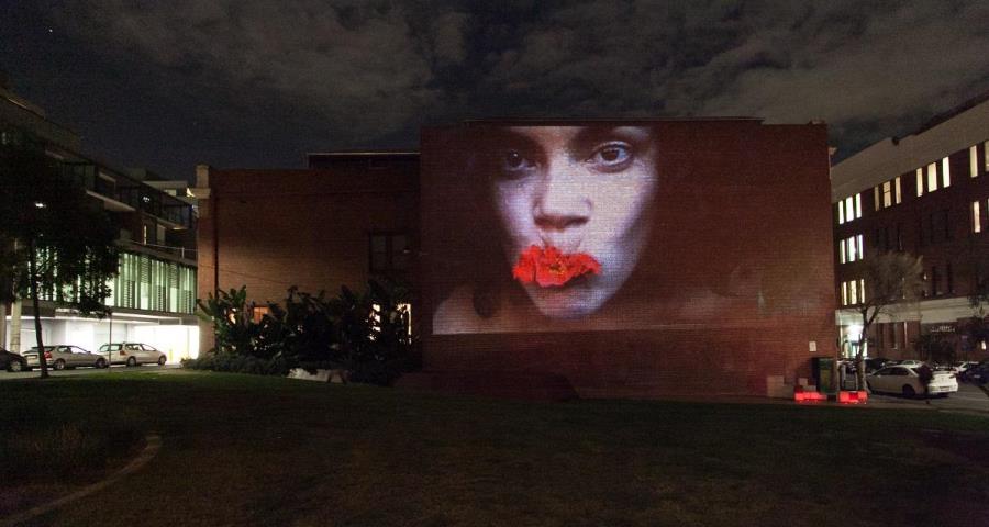 Woman's face projected onto building