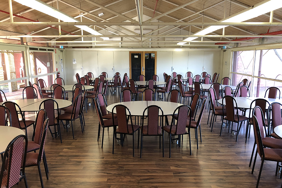 A community hall with round tables and chairs setup for a function