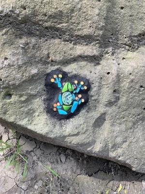 painting of a blue frog on a stone
