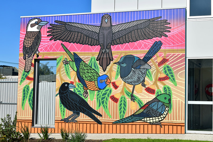Colourful mural of six birds on Richmond Kindergarten wall