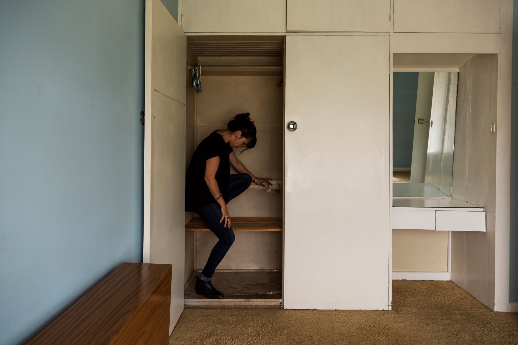 An image of a person in a closet