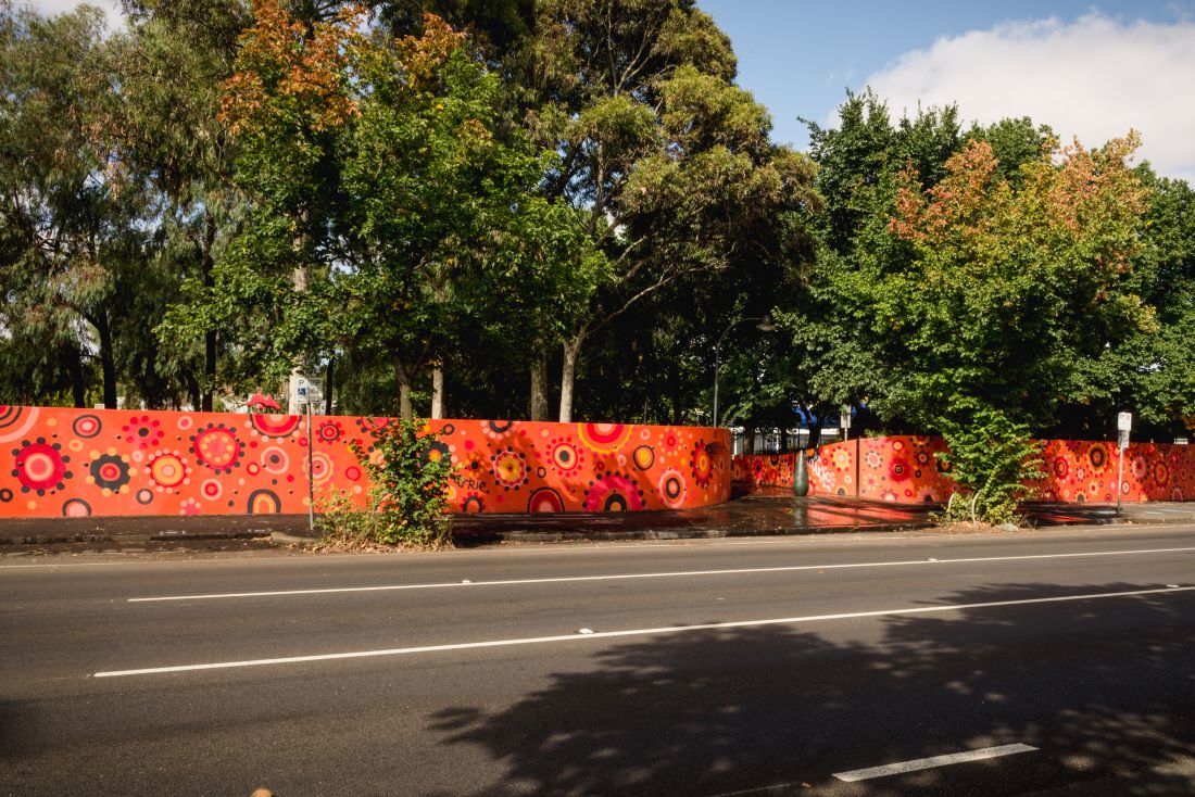 Arkie Bartons mural on Alexandra Parade which features strong reds oranges and blacks.