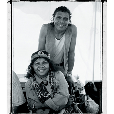 A black and white photograph taken between 1992 and 1994 of Archie Roach and Ruby Hunter, both smiling at the camera.