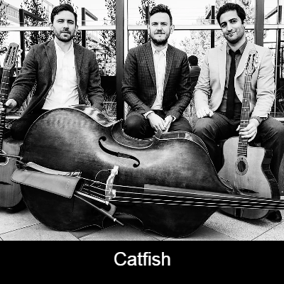 Three musician sitting in front of a cello. 