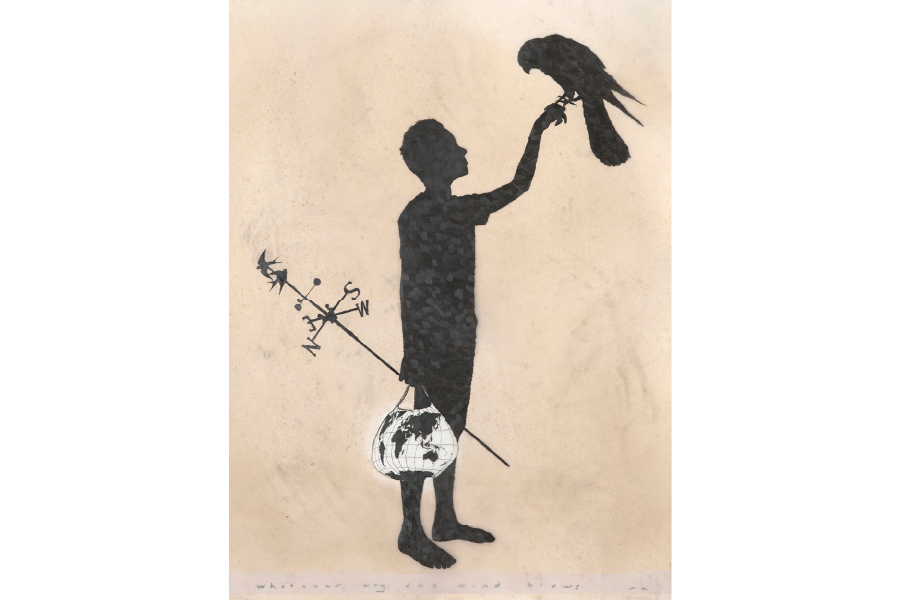 A person holding a bird in one hand and in the other is holding a bag with the world globe on it